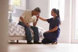 Nurse comforting man